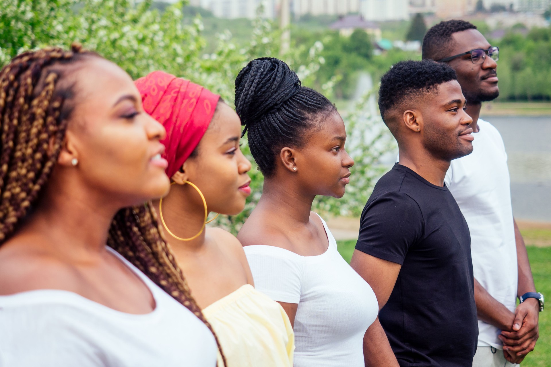 group of five smiling african-american men and women walking outside cloudy weather near the lake,exchange students in Russia group of five smiling african-american men and women walking outside cloudy weather near the lake,exchange students in Russia